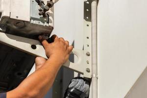 Close up of Air conditioning repair man hand uninstall air conditioner compressor, Technician fixing air conditioning system photo