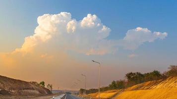 natural light of sky clouds and country roads photo