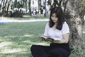 Young woman studying at the park photo