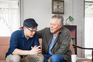 Senior asian father give advice adult son in living room, Happiness family concepts photo