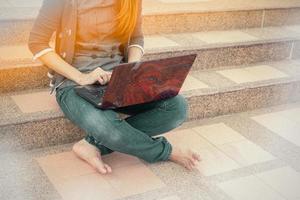 Woman searching for jobs with a laptop. photo