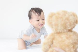 Portrait of a crawling little baby boy on the bed, Kids playing and Happiness concept photo