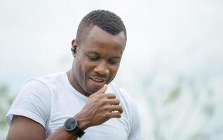 Cheerful african american man with wireless earpiece, Young handsome man smiling outdoor photo