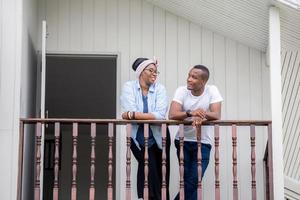 Cheerful african american couple at wooden balcony, happiness family concepts photo