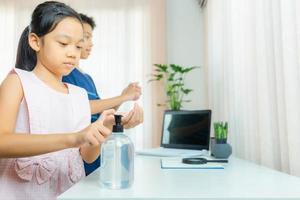 Kids washing hands with alcohol gel or antibacterial soap sanitizer gel pump dispenser. Hygiene concept.