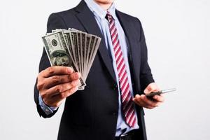 Businessman in suit holding several 100 dollar bills. Finance concept. photo