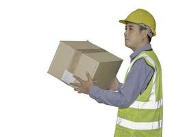 Portrait of an Asian handsome man warehouse worker is smiled happily while lifting the goods to arrange for delivery to the customers inside the warehouse. real people and real bodies concept. photo