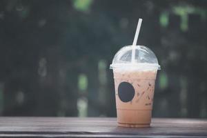Iced coffee in plastic glass with straw photo