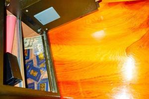 Open treasure chest filled with fine gold and Bank note dollar... on wooden table background. photo