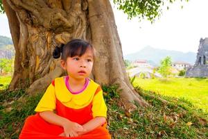 Lovely Baby girl wears yellow-orange outfit gokowa outfit, Mugunghwa in a public park. Girls and teen fashion dress. photo