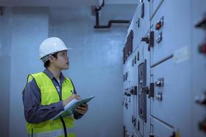 Engineer checking and inspecting at MDB panel .they working with electric switchboard to check range of voltage working in Main Distribution Boards factory. photo