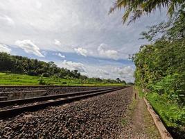 The view of the rail road in Yogyakarta Indonesia, visible rocks and a clear sky background photo