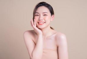 Attractive young Asian woman with fresh skin. Face care, facial treatment, , woman beauty skin isolated on white background. cosmetology, beauty skin and cosmetic concept photo