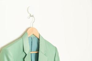 green suit hanging with wood hanger photo