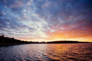 beautiful sunset over the lake. Cumulus clouds at photo