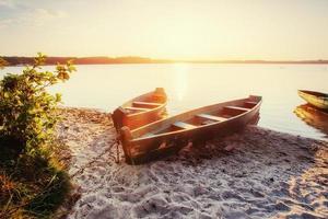 boat on the lake at sunset photo