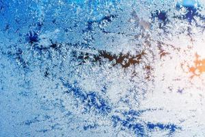 texture of patterns on frozen window glass photo