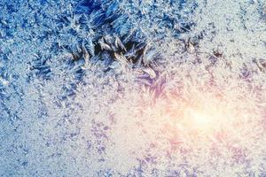 Frosty natural pattern on winter window photo