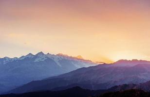 Autumn landscape and snow-capped mountain peaks. View of the mou photo