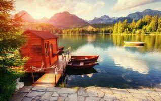 Boat on the dock surrounded by mountains at sunset. Fantastic Sh photo