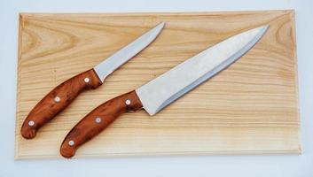 knife on an wooden cutting board photo