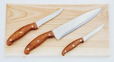 knife on an wooden cutting board photo