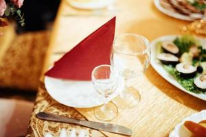 Formal stylish setting on a dinner table with elegant glassware photo