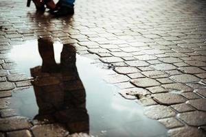 reflected in a puddle couple outdoors road photo