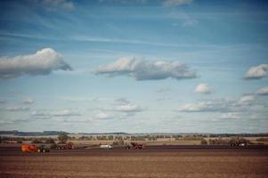 Tractor plowing up the field. photo