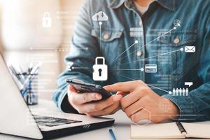 Concept Internet security and cyber network. businessman's hand works with a key icon virtual screen a cell phone on a computer, laptop, and a digital tablet. photo