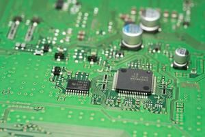 chip on green pcb board. Electronic circuit board close up. photo