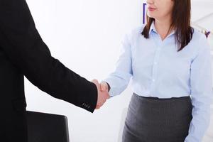 Stylish Successful businessman and businesswoman handshake in suits at office background . Copy space and selective focus. Business partnership concept. photo