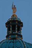 Golden european statue on the dome photo