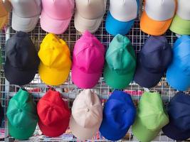 Side view of colorful hats for sale in the market photo