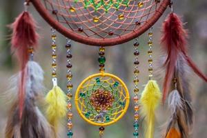 Dreamcatcher made of feathers, leather, beads, and ropes photo