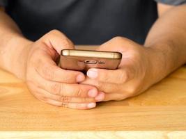 Close up of a man using mobile smart phone.A man hands holding touch screen smartphone. photo