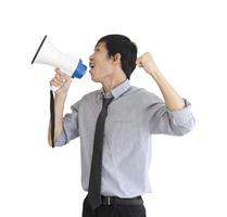 An Asian man stands holding a blue megaphone and white isolated on white background. photo