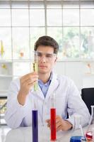 A male scientist working in a science lab with various equipment in the lab photo