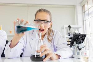 A beautiful female scientist is operating in a science lab with various equipment in the lab. photo