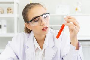 A beautiful female scientist is operating in a science lab with various equipment in the lab. photo