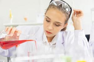 A beautiful female scientist is operating in a science lab with various equipment in the lab. photo