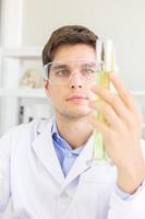 A male scientist working in a science lab with various equipment in the lab photo