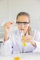 A beautiful female scientist is operating in a science lab with various equipment in the lab. photo