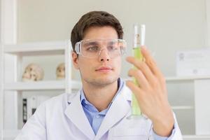 A male scientist working in a science lab with various equipment in the lab photo