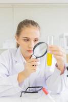 A beautiful female scientist is operating in a science lab with various equipment in the lab. photo