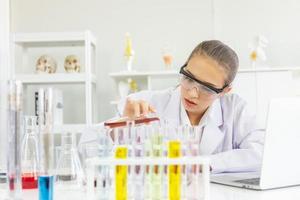 A beautiful female scientist is operating in a science lab with various equipment in the lab. photo