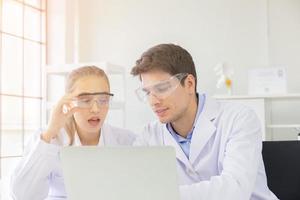 The concept of health care researchers, researchers working in biological science laboratories, young research scientists and male supervisors photo