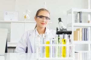 A beautiful female scientist is operating in a science lab with various equipment in the lab. photo