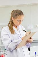 Portrait of a female scientist in a laboratory researching a scientific work using laboratory equipment photo