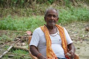 anciano indio sentado en la granja foto